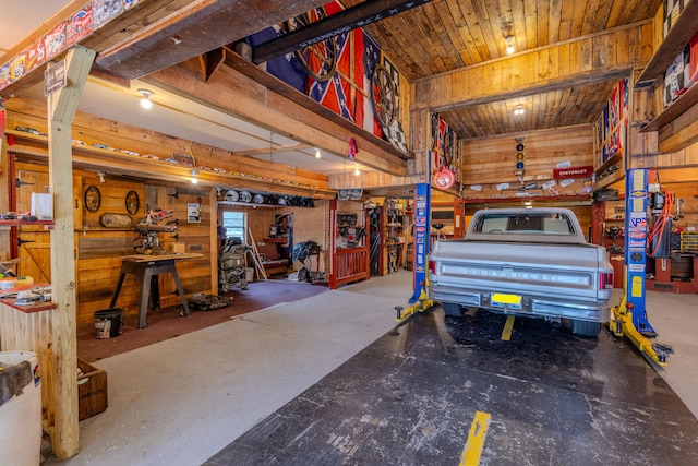 garage with a workshop area and wood walls