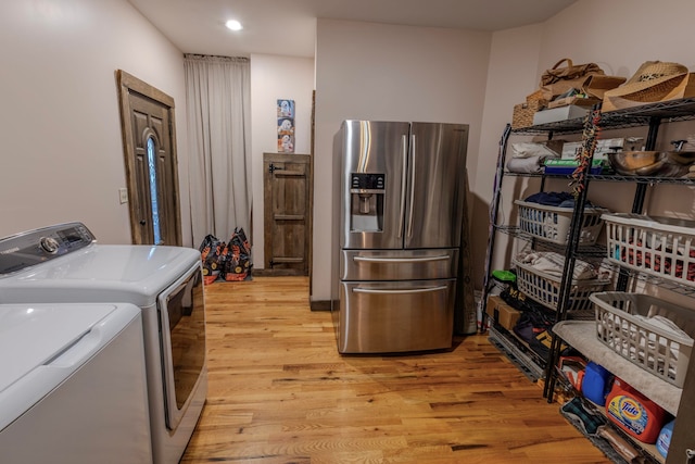 laundry area featuring light hardwood / wood-style floors and independent washer and dryer