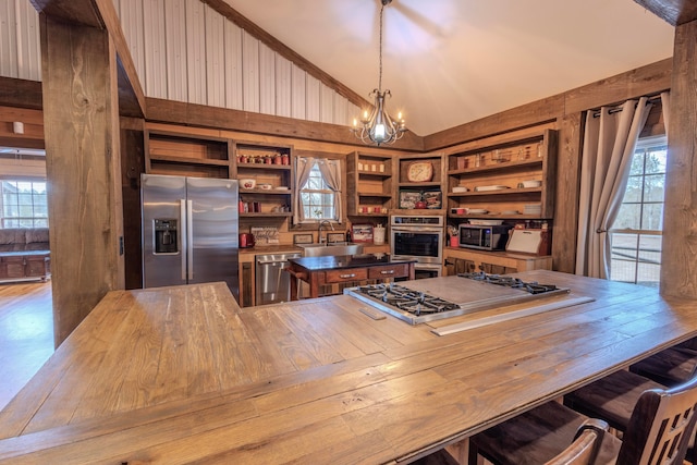 home office with built in features, a notable chandelier, high vaulted ceiling, and a healthy amount of sunlight