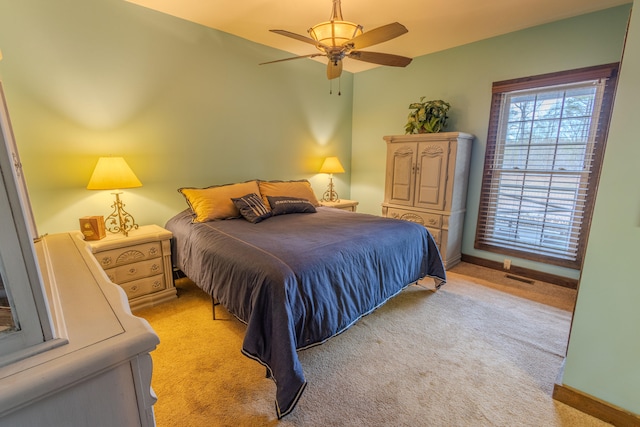 bedroom with light carpet and ceiling fan