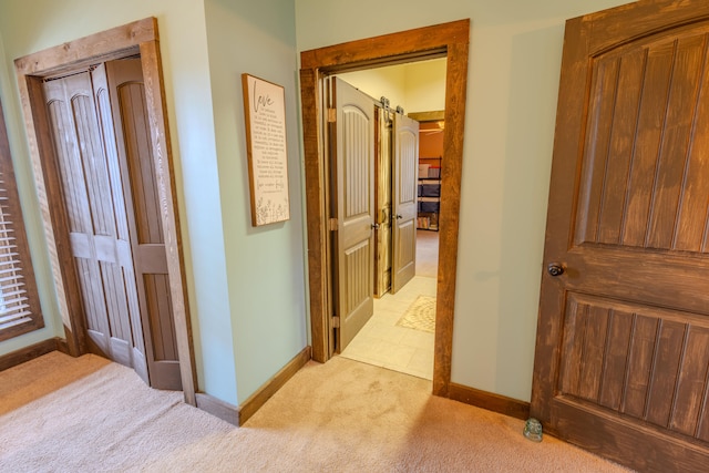 hallway with light colored carpet