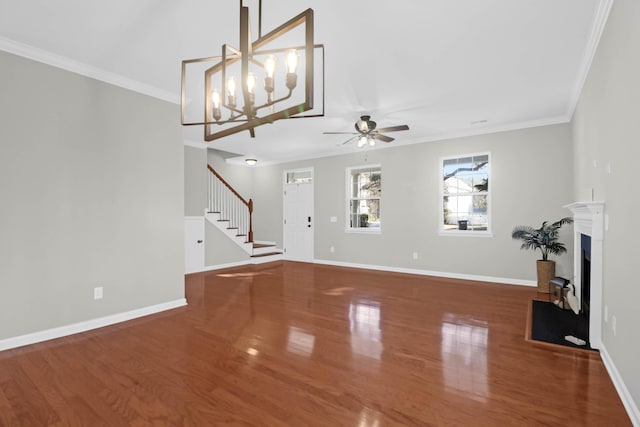 unfurnished living room featuring crown molding, ceiling fan with notable chandelier, and hardwood / wood-style flooring