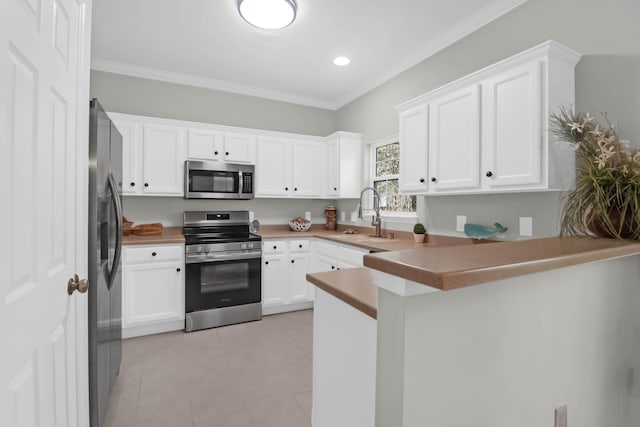 kitchen featuring white cabinetry, sink, kitchen peninsula, stainless steel appliances, and crown molding