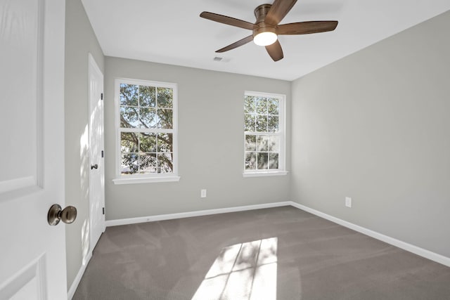 empty room with ceiling fan and carpet