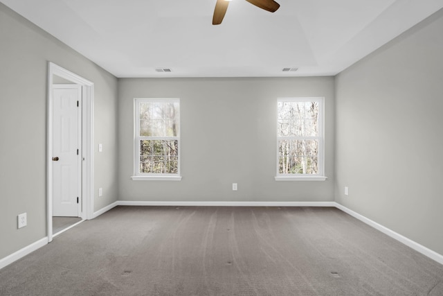 spare room featuring carpet and ceiling fan