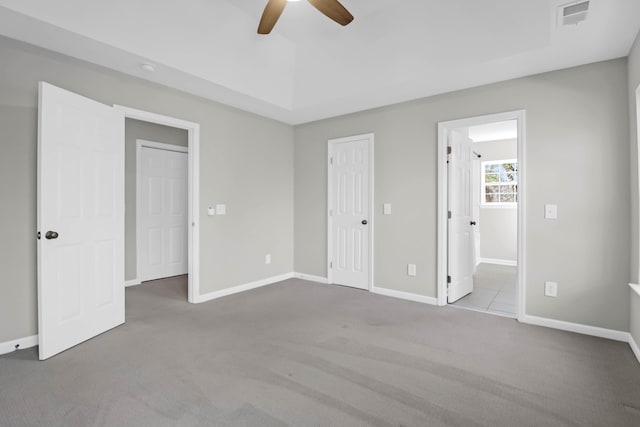 unfurnished bedroom featuring ceiling fan and light colored carpet