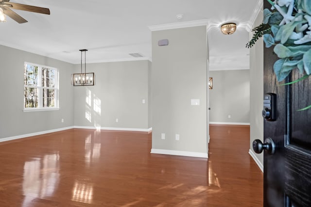 unfurnished room featuring dark hardwood / wood-style flooring, ceiling fan with notable chandelier, and ornamental molding