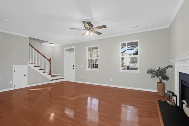 unfurnished living room featuring hardwood / wood-style flooring, crown molding, and ceiling fan