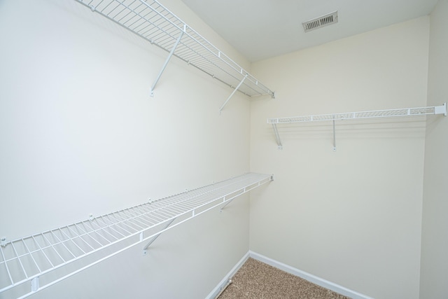 walk in closet featuring carpet and visible vents