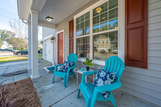 view of patio / terrace with a garage and a porch