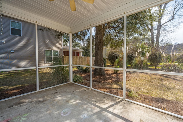 unfurnished sunroom with ceiling fan