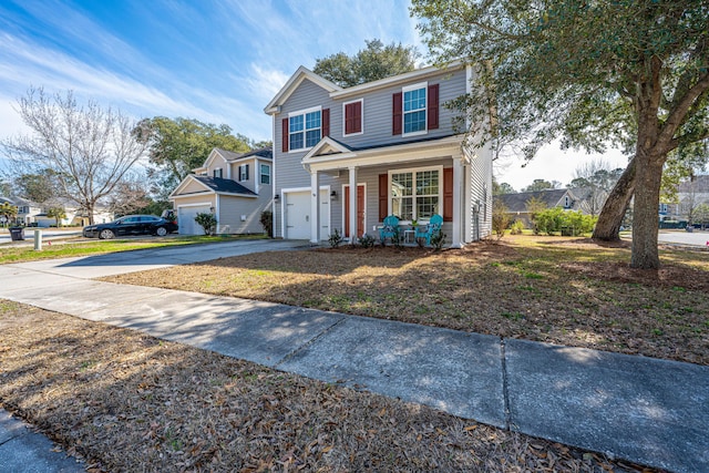 traditional home with driveway, covered porch, and an attached garage