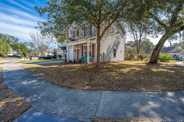 view of front of property featuring a residential view and a front lawn