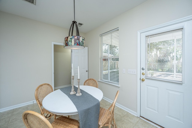 dining room featuring light tile patterned floors, visible vents, and baseboards