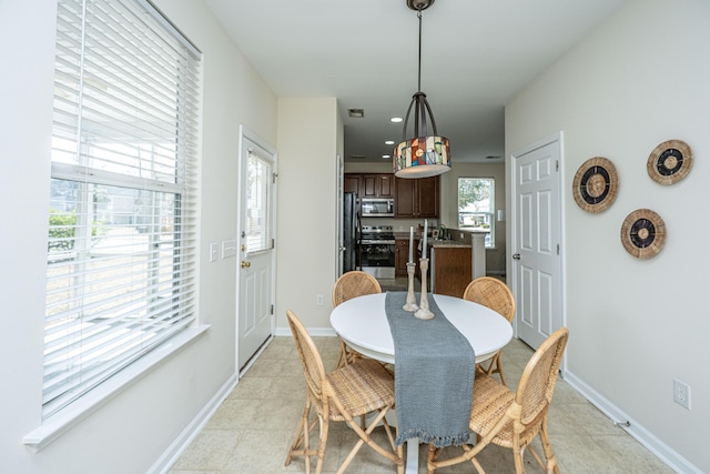 dining area with light tile patterned floors, baseboards, and recessed lighting