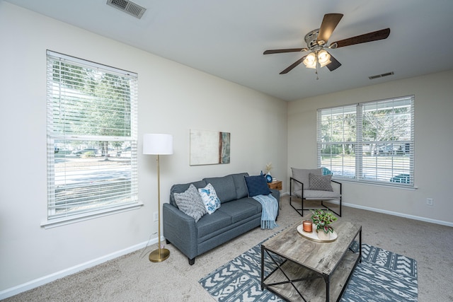 living area featuring carpet, visible vents, and baseboards