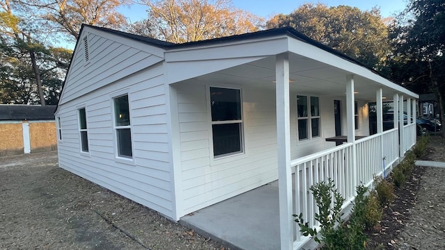 view of side of home with covered porch