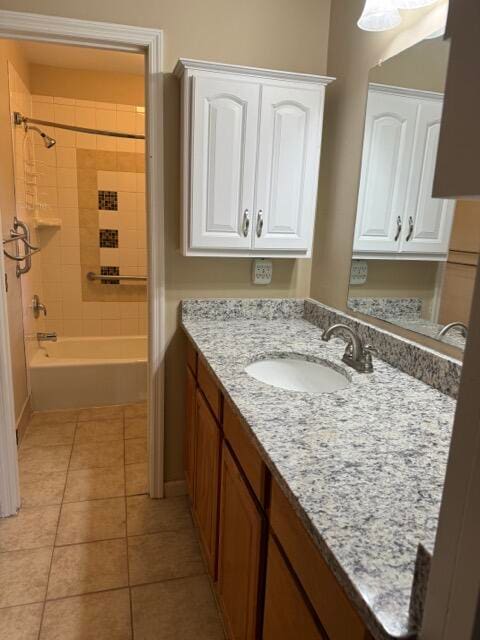 bathroom featuring tile patterned floors, vanity, and tiled shower / bath