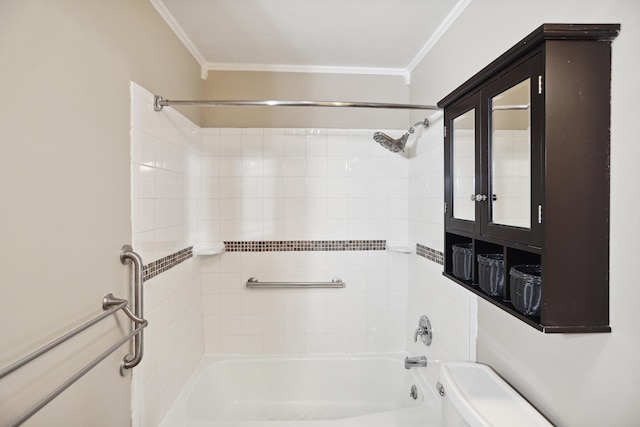 bathroom featuring tiled shower / bath, ornamental molding, and toilet