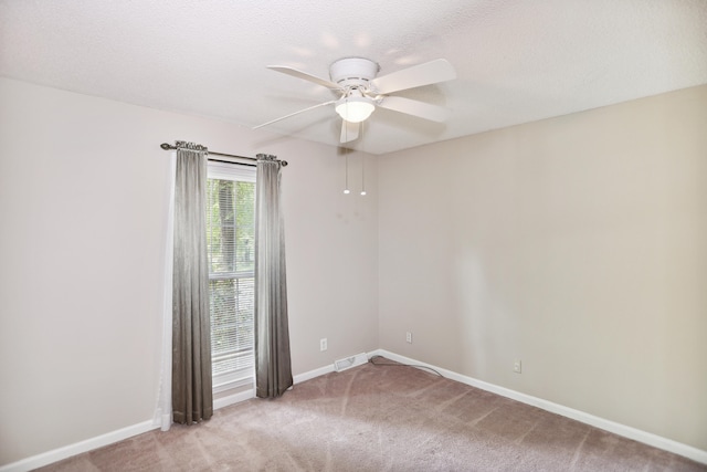 carpeted empty room with a textured ceiling and ceiling fan