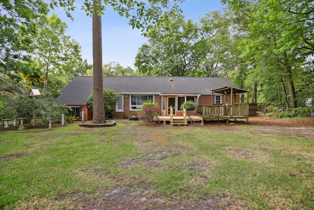 back of house with a wooden deck and a yard