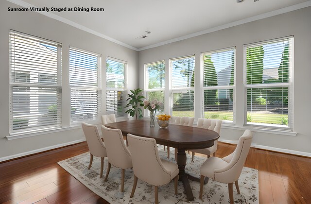 dining room with a notable chandelier, sink, and crown molding