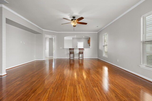 unfurnished bedroom featuring a spacious closet, a closet, ceiling fan, and light colored carpet