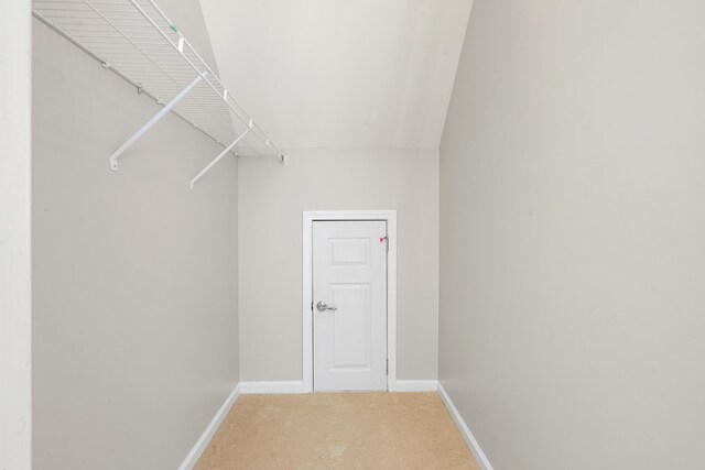 unfurnished sunroom with vaulted ceiling, an AC wall unit, and ceiling fan