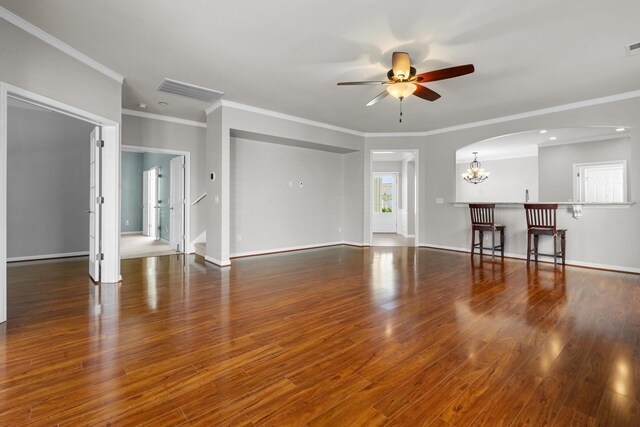 empty room with ornamental molding, light hardwood / wood-style flooring, and a notable chandelier