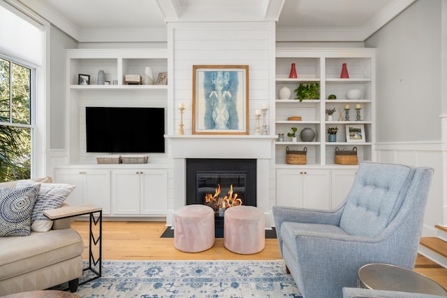 living room with ornamental molding and light wood-type flooring