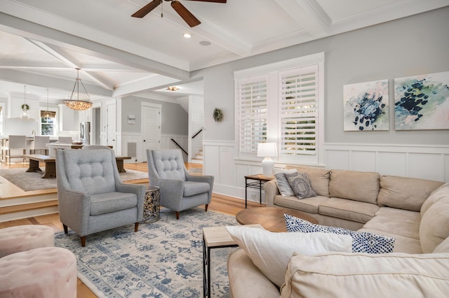 living room with hardwood / wood-style floors, coffered ceiling, ceiling fan, ornamental molding, and beamed ceiling