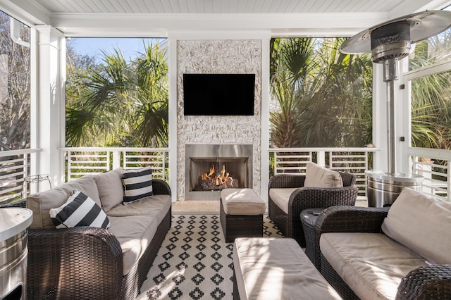 sunroom featuring a fireplace and wooden ceiling