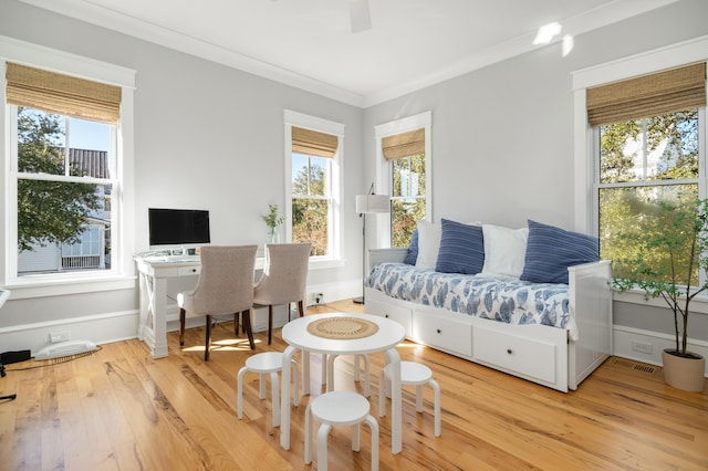 living room featuring hardwood / wood-style flooring and crown molding