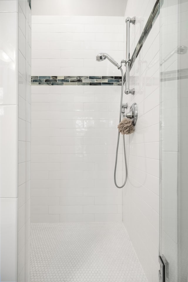 bathroom featuring a shower with door