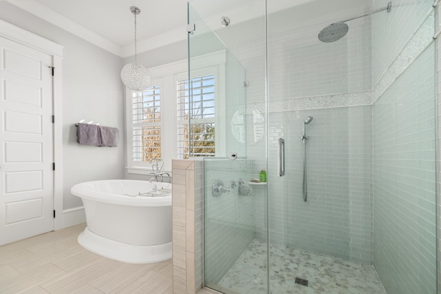 bathroom with separate shower and tub and ornamental molding