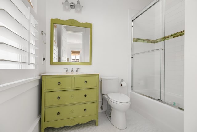 full bathroom featuring tile patterned flooring, vanity, toilet, and combined bath / shower with glass door