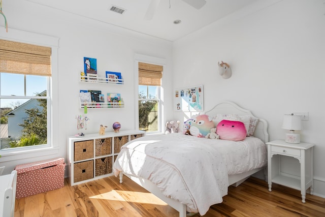 bedroom with hardwood / wood-style flooring and ceiling fan