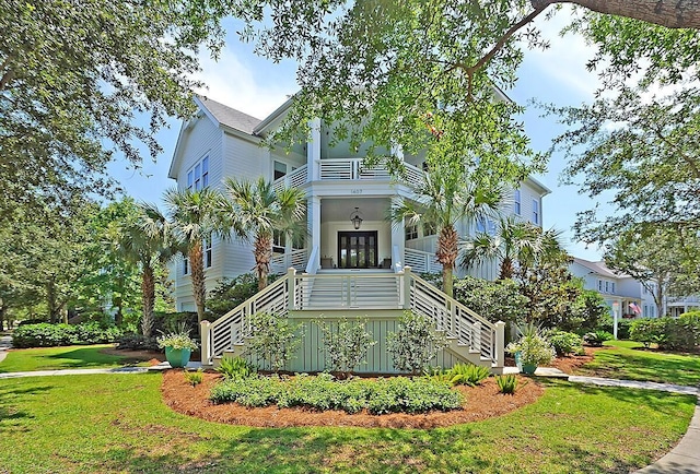 beach home with a porch and a front yard