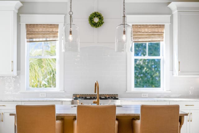 dining space featuring a healthy amount of sunlight and sink