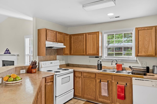 2919 Fernwood Dr, North Charleston, SC 29406 - kitchen with a sink, white appliances, light countertops, under cabinet range hood, and visible vents