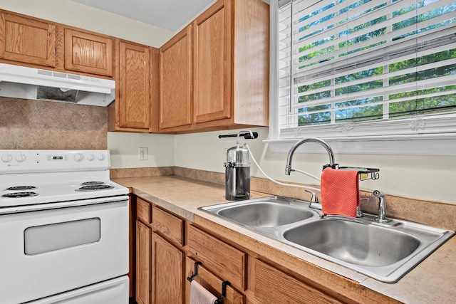 2919 Fernwood Dr, North Charleston, SC 29406 - kitchen with brown cabinets, a sink, light countertops, white range with electric stovetop, and under cabinet range hood