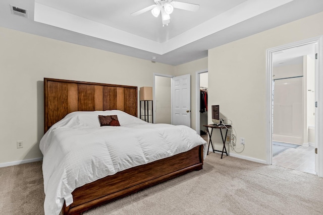2919 Fernwood Dr, North Charleston, SC 29406 - carpeted bedroom featuring visible vents, ensuite bathroom, baseboards, a raised ceiling, and a spacious closet