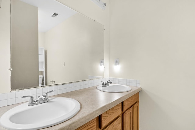 2919 Fernwood Dr, North Charleston, SC 29406 - full bath with visible vents, a sink, decorative backsplash, and toilet