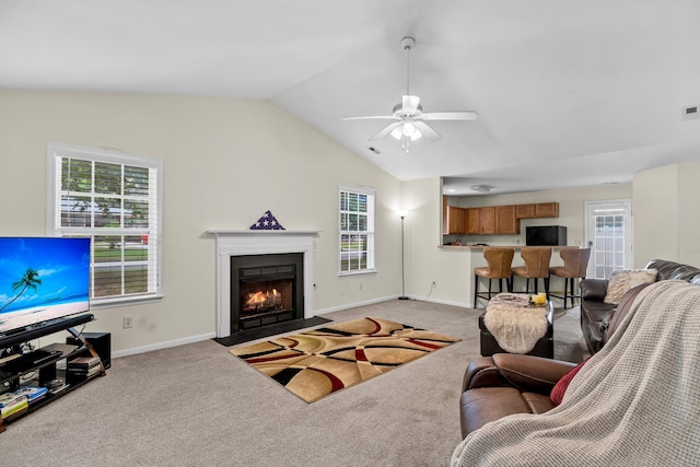 2919 Fernwood Dr, North Charleston, SC 29406 - living area featuring a fireplace with flush hearth, a ceiling fan, vaulted ceiling, and light colored carpet