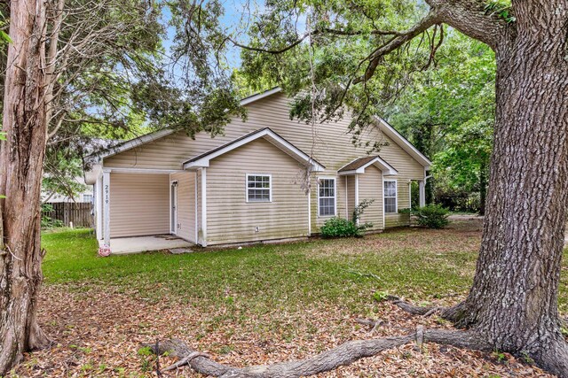 2919 Fernwood Dr, North Charleston, SC 29406 - view of front of house with fence, a patio area, and a front lawn