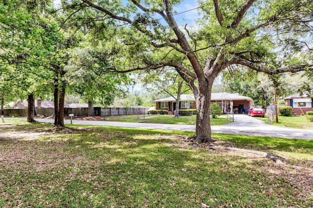 2919 Fernwood Dr, North Charleston, SC 29406 - view of yard with fence, driveway, and a detached carport