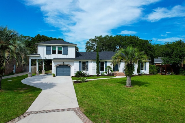 1468 N Relyea Ave, Charleston, SC 29412 - view of front of home with board and batten siding, concrete driveway, a front lawn, and a garage