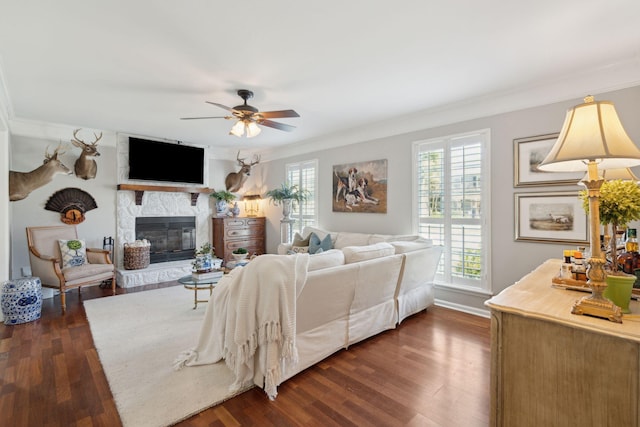 living room featuring a fireplace, dark hardwood / wood-style flooring, and crown molding