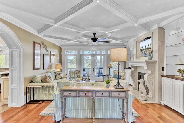 living room with french doors, light hardwood / wood-style floors, ceiling fan, and a healthy amount of sunlight