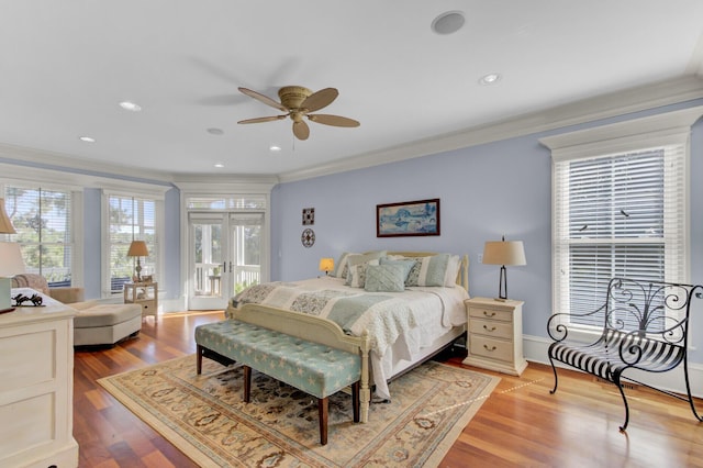 bedroom with french doors, light hardwood / wood-style flooring, ceiling fan, and crown molding